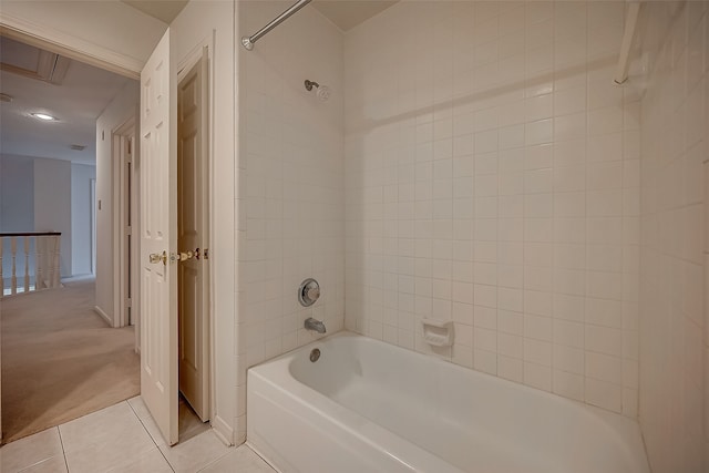 bathroom featuring tiled shower / bath combo and tile patterned flooring