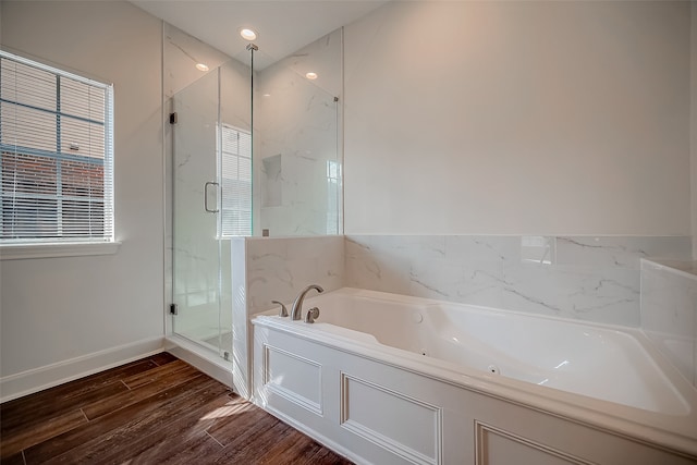 bathroom with hardwood / wood-style floors and plus walk in shower