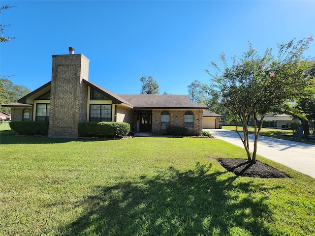 single story home featuring a garage and a front lawn