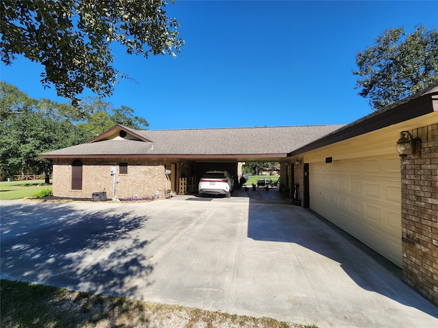 view of side of home with a carport and a garage