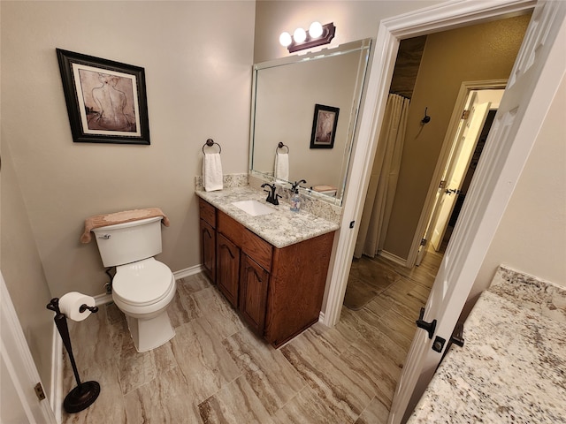 bathroom featuring vanity, toilet, and hardwood / wood-style flooring