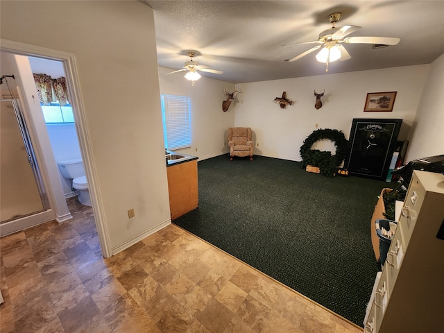 interior space with carpet floors and ceiling fan