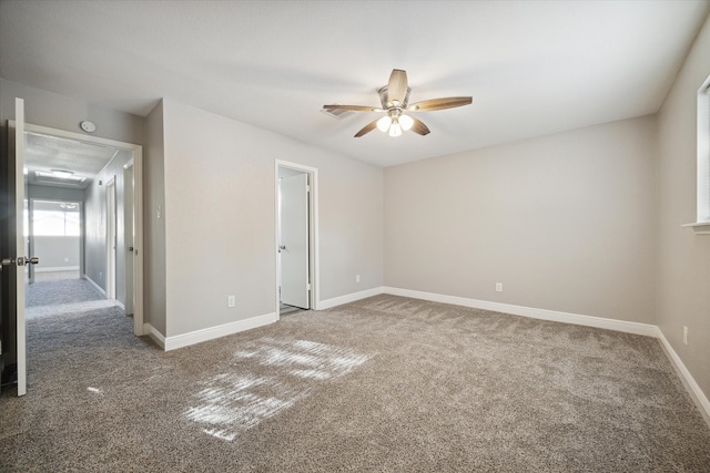 carpeted empty room featuring ceiling fan