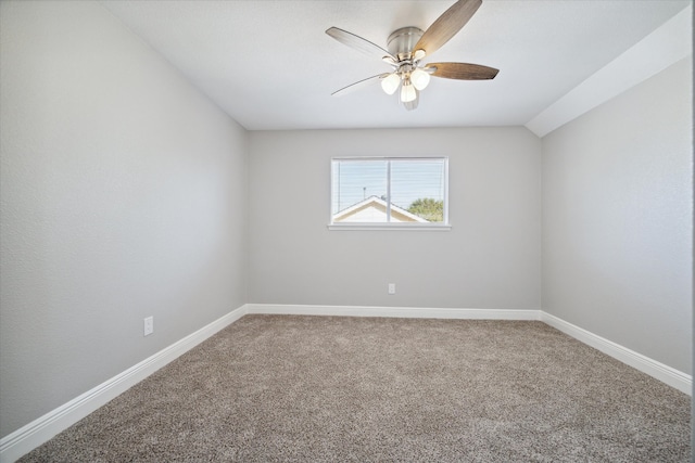 carpeted empty room with vaulted ceiling and ceiling fan