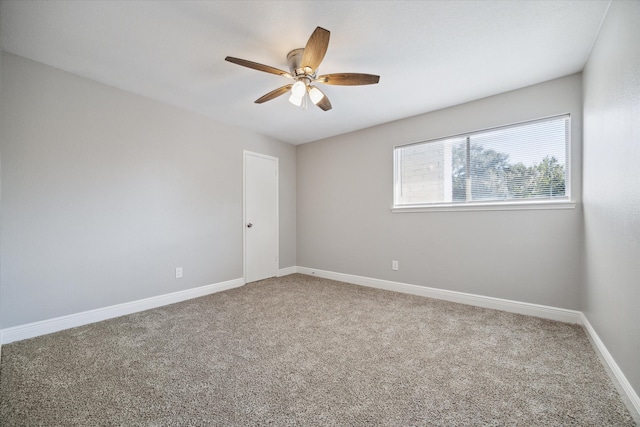 unfurnished room featuring ceiling fan and carpet flooring