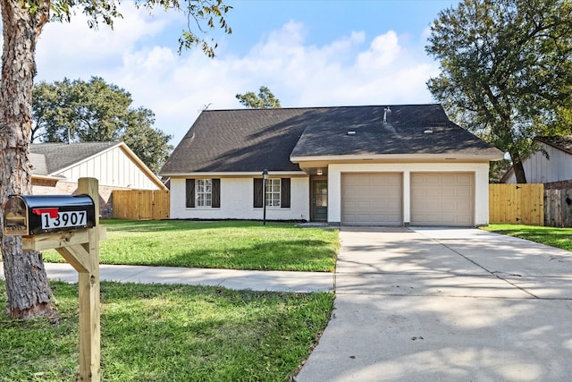 view of front of property featuring a garage and a front lawn