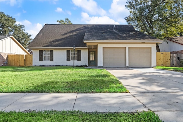 view of front facade featuring a front lawn and a garage