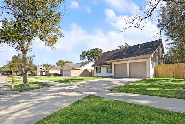 view of front of property featuring a front lawn and a garage