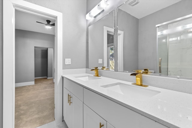 bathroom featuring a shower with door, vanity, and ceiling fan