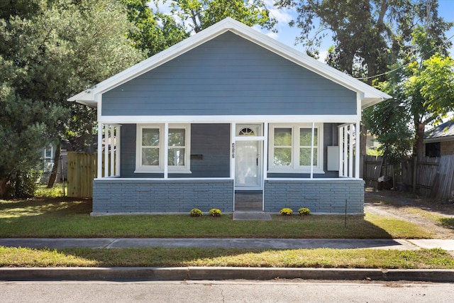 bungalow-style home featuring a front lawn