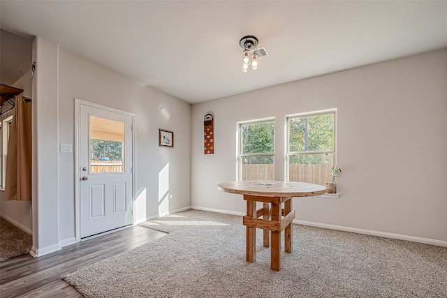 dining space with a wealth of natural light and hardwood / wood-style floors