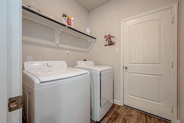 laundry area with separate washer and dryer and dark hardwood / wood-style flooring