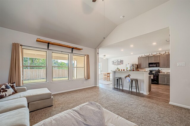 17624 Cedar Crest Dr, Conroe, TX 77306 - living room with light colored carpet, vaulted ceiling, ceiling fan, and recessed lighting