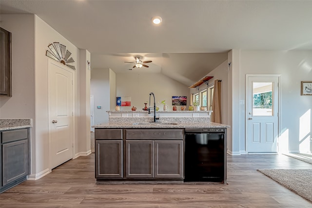 kitchen featuring lofted ceiling, hardwood / wood-style flooring, sink, black dishwasher, and dark brown cabinets