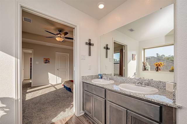 bathroom with hardwood / wood-style flooring, ceiling fan, and vanity