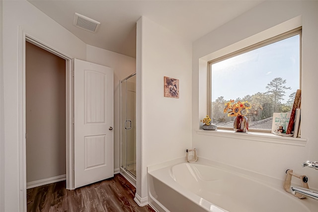 17624 Cedar Crest Dr, Conroe, TX 77306 - bathroom featuring a bath, a stall shower, and wood finished floors