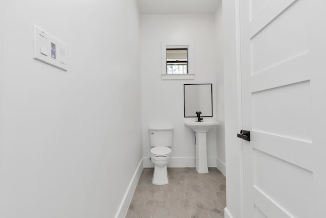 bathroom featuring toilet and tile patterned floors