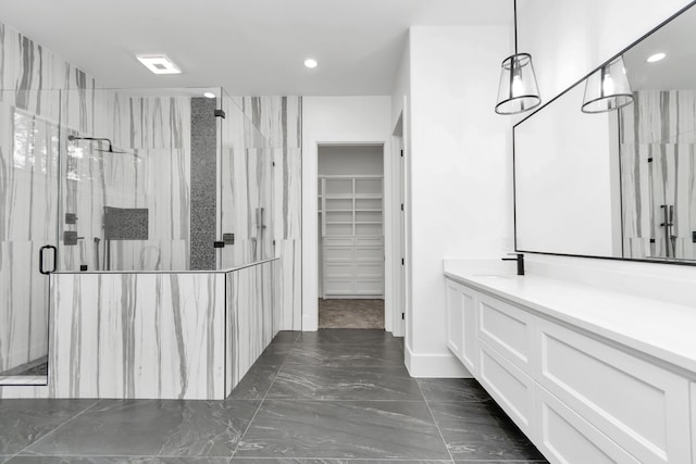 bathroom with vanity and a shower with shower door