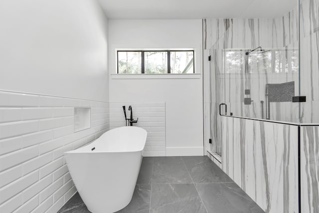 bathroom featuring shower with separate bathtub