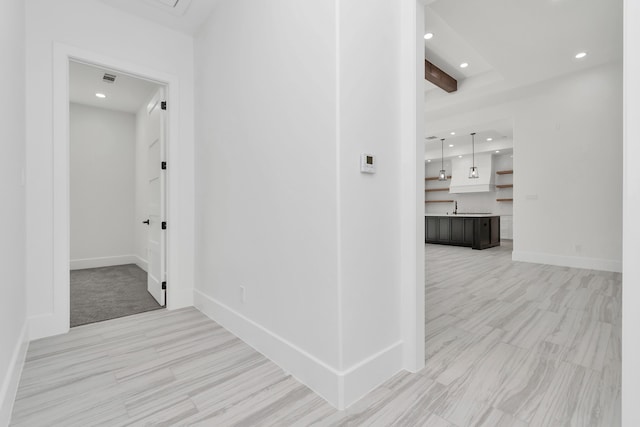 hallway featuring beamed ceiling