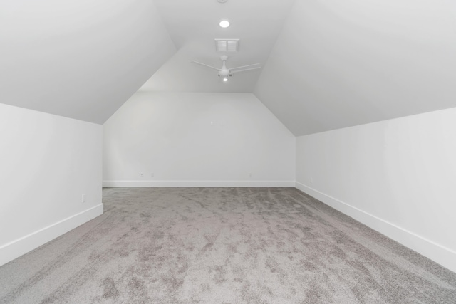 additional living space with vaulted ceiling and carpet floors