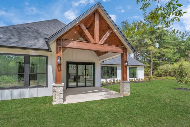 back of property featuring a lawn and a patio