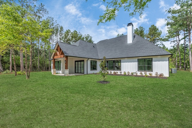 rear view of house featuring a patio, central AC unit, and a yard