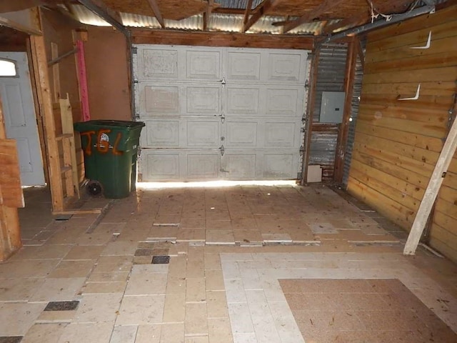 garage with wooden walls and electric panel