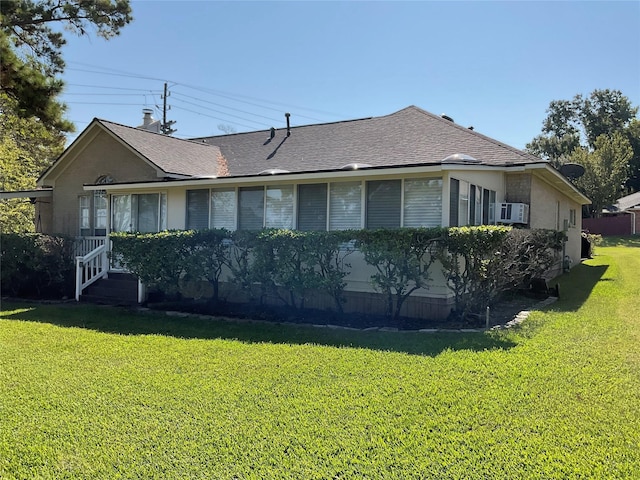 rear view of property featuring a lawn