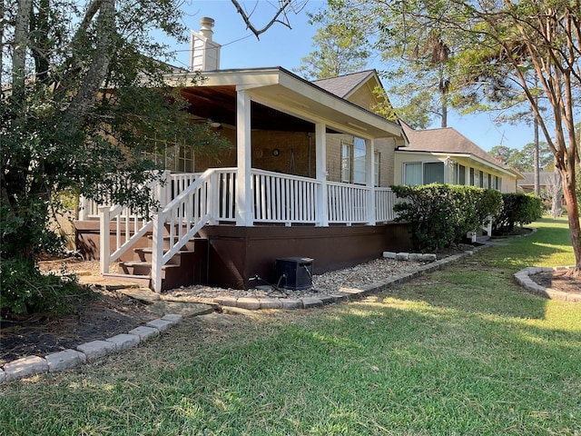 view of side of home with a yard