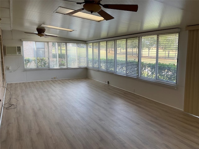 unfurnished sunroom featuring a wall mounted AC, ceiling fan, and vaulted ceiling