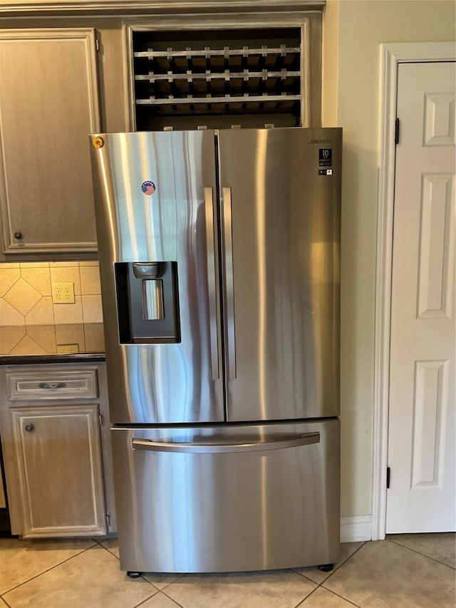 kitchen with stainless steel fridge with ice dispenser, backsplash, and light tile patterned floors