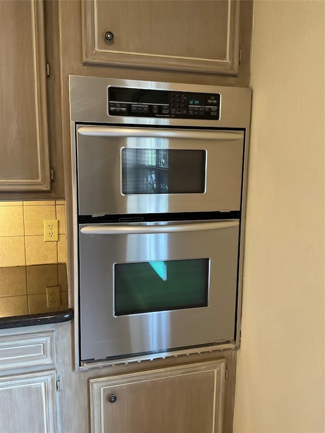 details with light brown cabinetry, tasteful backsplash, and double oven