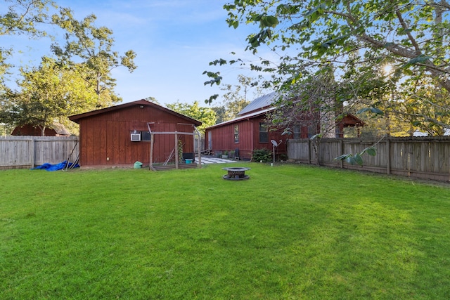 view of yard with an outdoor structure and a fire pit