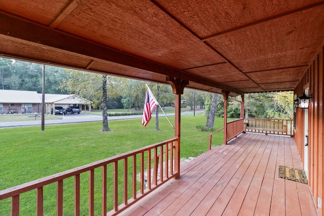 wooden terrace featuring a lawn