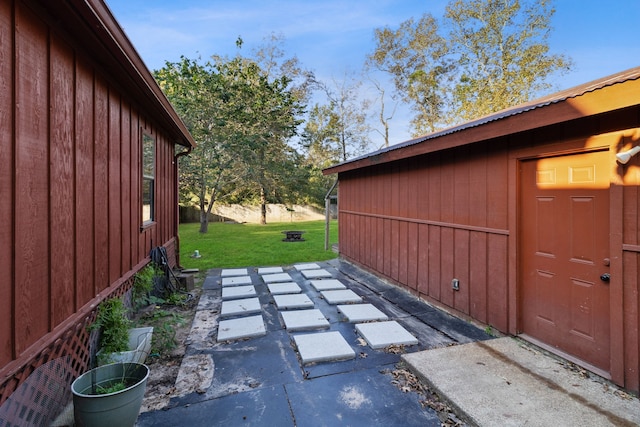 view of side of property with a patio and a yard