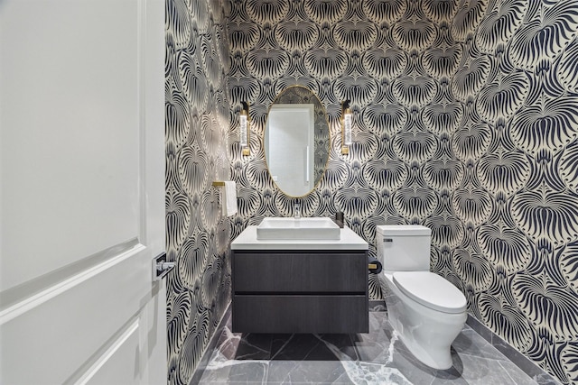 bathroom featuring vanity and toilet