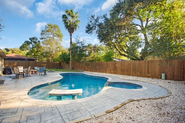 view of pool featuring a patio and a jacuzzi