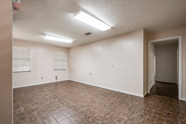 empty room featuring a textured ceiling