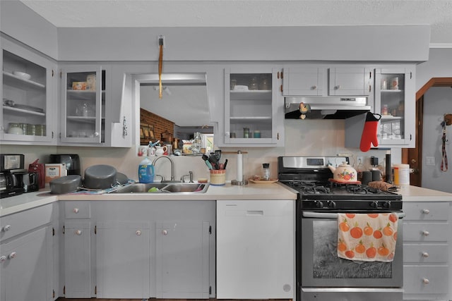 kitchen featuring sink, a textured ceiling, stainless steel gas range oven, and dishwasher