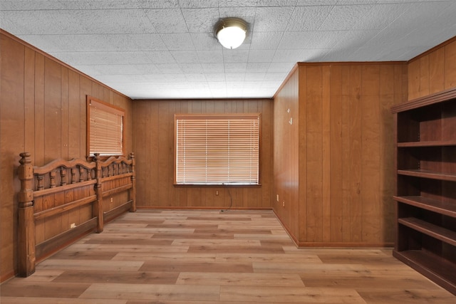 interior space featuring light hardwood / wood-style flooring and wooden walls