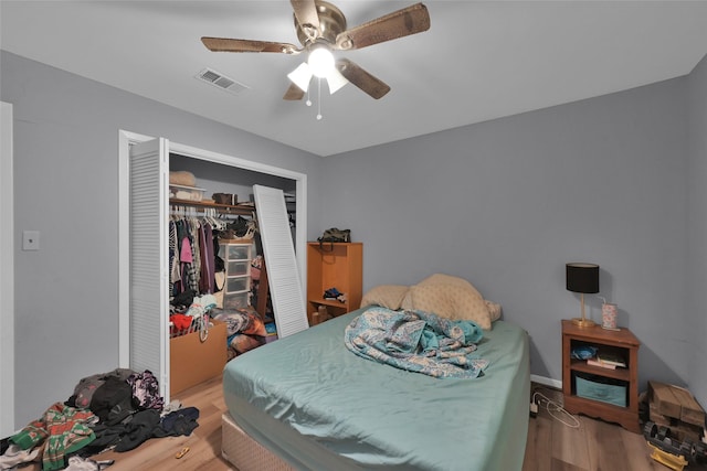 bedroom featuring ceiling fan, a closet, and light wood-type flooring