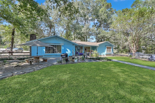 ranch-style home with a front lawn