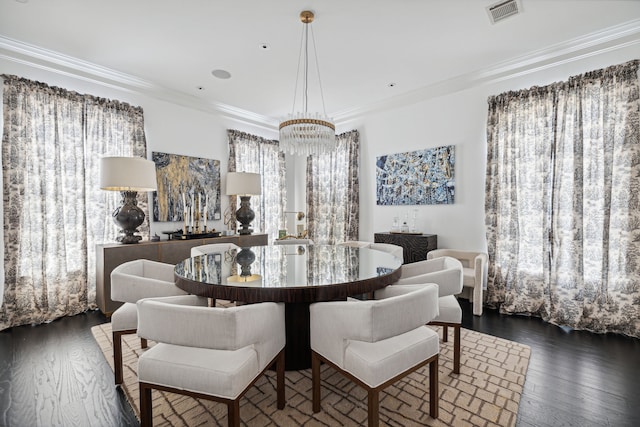 dining space with crown molding, a chandelier, and dark hardwood / wood-style flooring