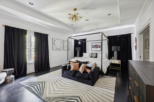 bedroom with ornamental molding, dark hardwood / wood-style flooring, and a raised ceiling