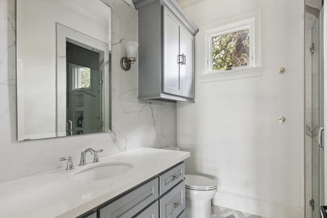 bathroom with a shower with door, vanity, toilet, and decorative backsplash