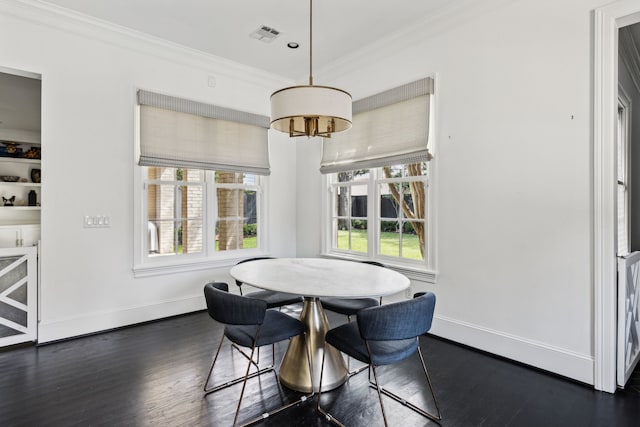 dining area with crown molding and dark wood-type flooring