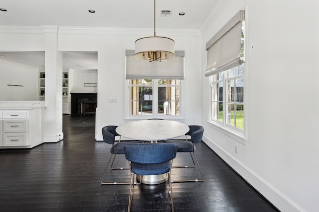 dining area featuring ornamental molding and dark wood-type flooring