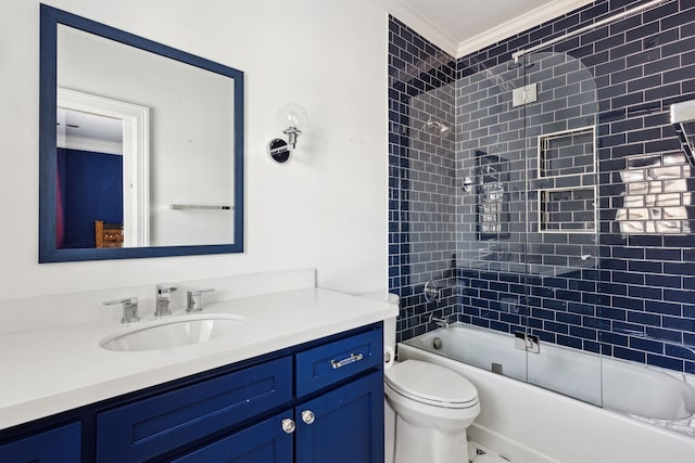 full bathroom featuring toilet, ornamental molding, bath / shower combo with glass door, and vanity