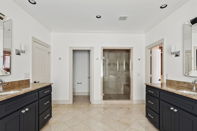 bathroom featuring tile patterned floors, ornamental molding, a shower with door, and vanity